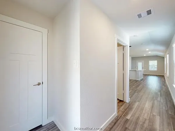 a view of hallway with wooden floor