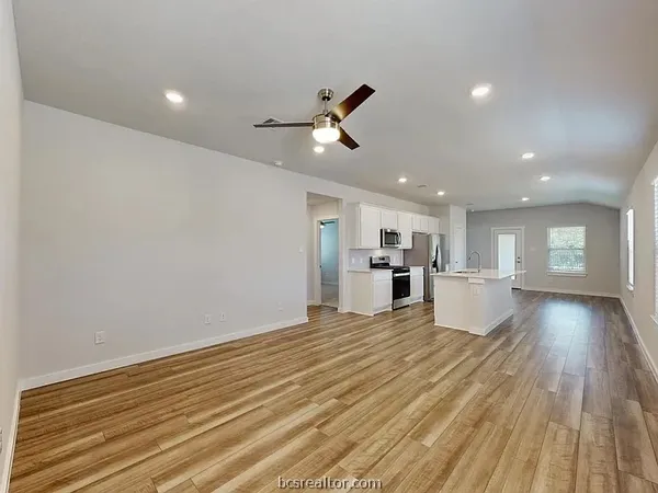 a view of a kitchen with wooden floor and a kitchen