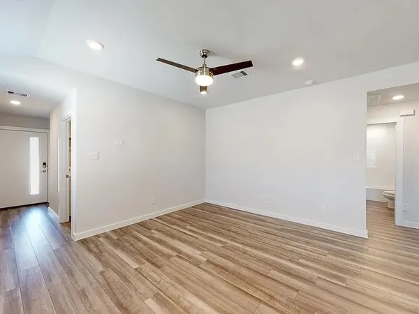 wooden floor in an empty room with a window