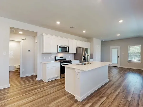a view of kitchen with sink microwave and refrigerator