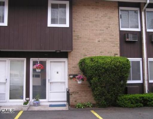 59 Rock Spring Road, Unit 27 Stamford, CT 06906 - Photo 1 of 1 a front view of a house with garage