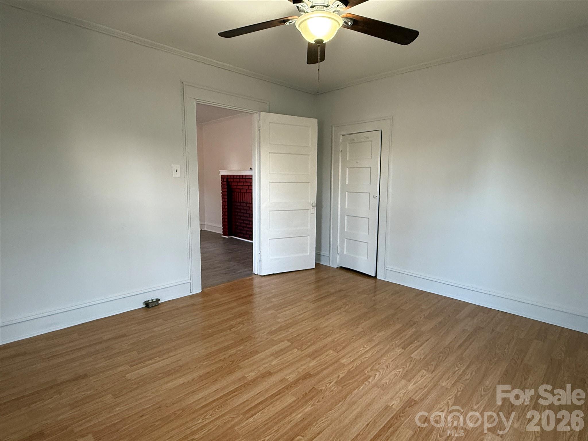 2603 5th Avenue Southwest Hickory, NC 28602 - Photo 13 of 31 an empty room with wooden floor chandelier fan and windows