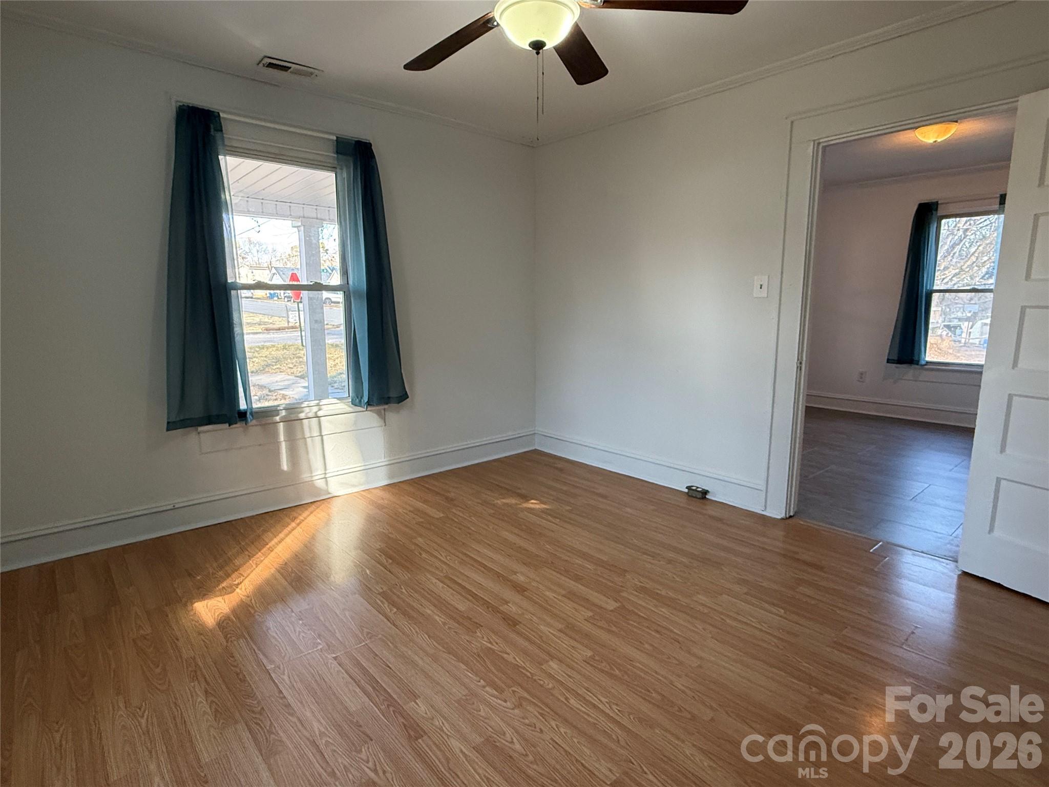 2603 5th Avenue Southwest Hickory, NC 28602 - Photo 14 of 31 an empty room with wooden floor and windows