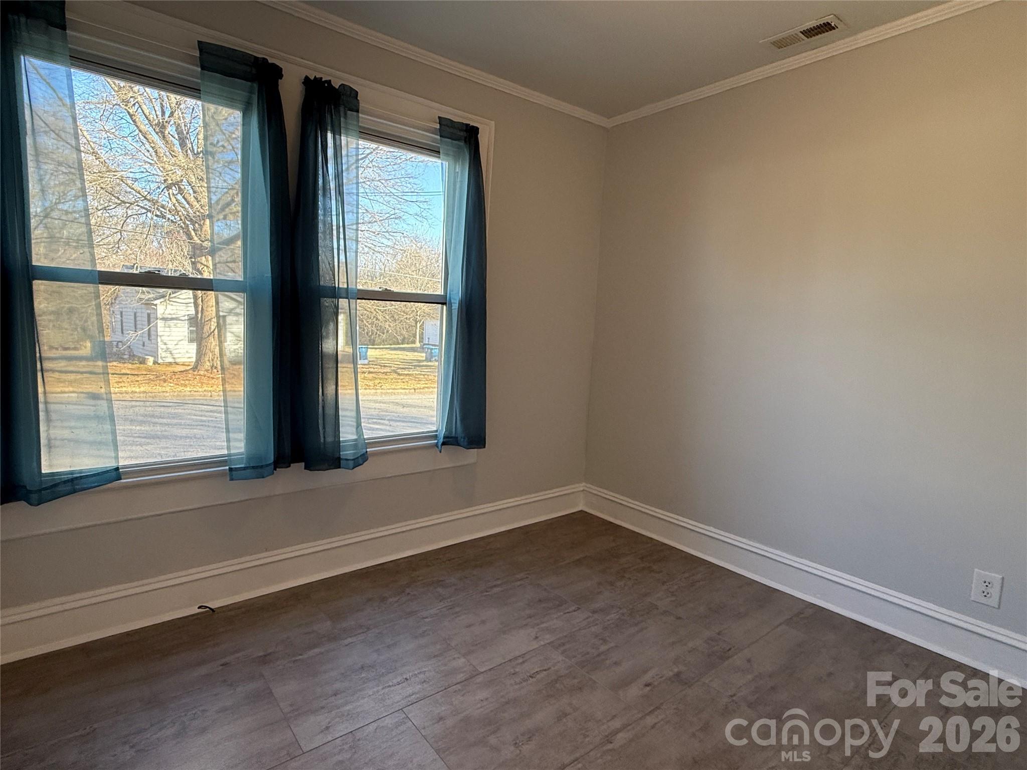 2603 5th Avenue Southwest Hickory, NC 28602 - Photo 15 of 31 an empty room with wooden floor and windows