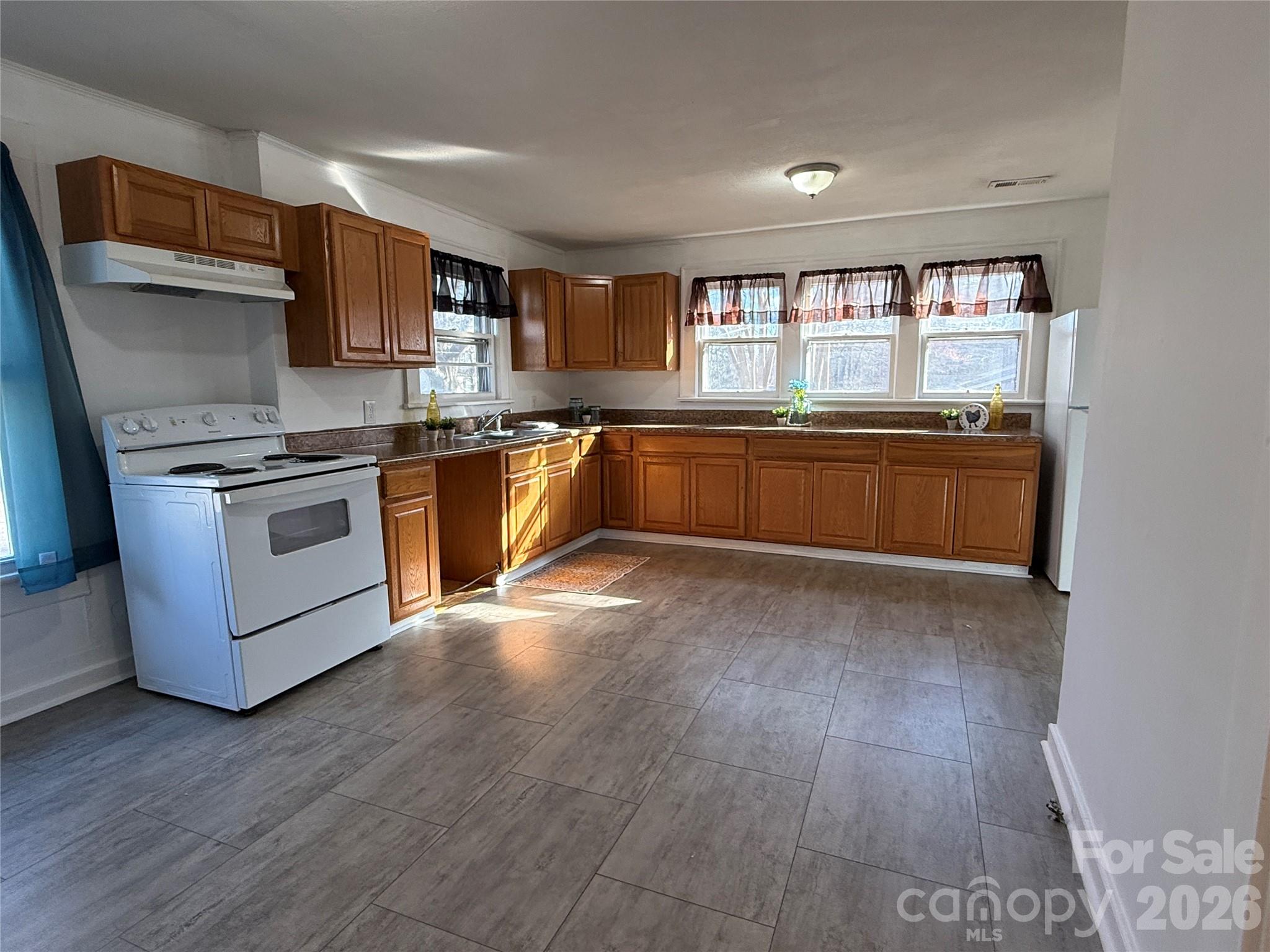 2603 5th Avenue Southwest Hickory, NC 28602 - Photo 21 of 31 a kitchen with stainless steel appliances granite countertop a stove a sink and a refrigerator