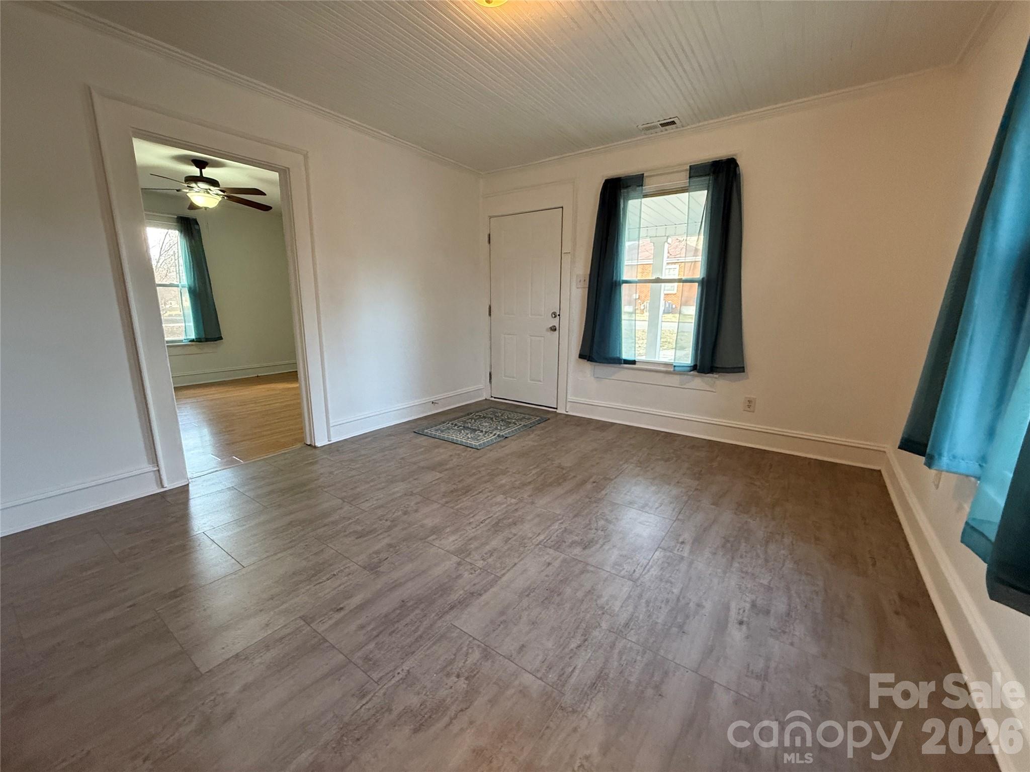 2603 5th Avenue Southwest Hickory, NC 28602 - Photo 8 of 31 an empty room with wooden floor and windows