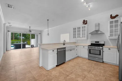 a kitchen with stainless steel appliances a stove a refrigerator and a sink