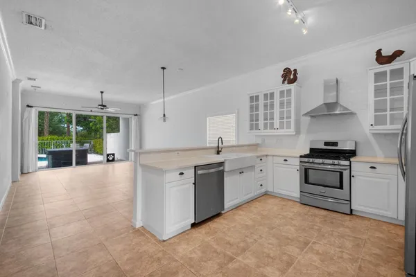 a kitchen with stainless steel appliances a stove a refrigerator and a sink