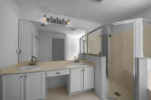 a bathroom with a granite countertop sink a toilet and a mirror