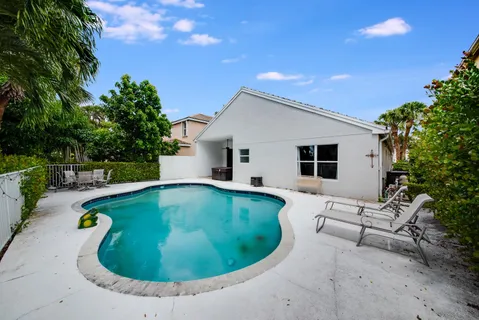 an aerial view of residential house with outdoor space and swimming pool