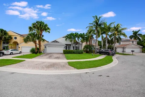 an aerial view of a house with a garden and a yard