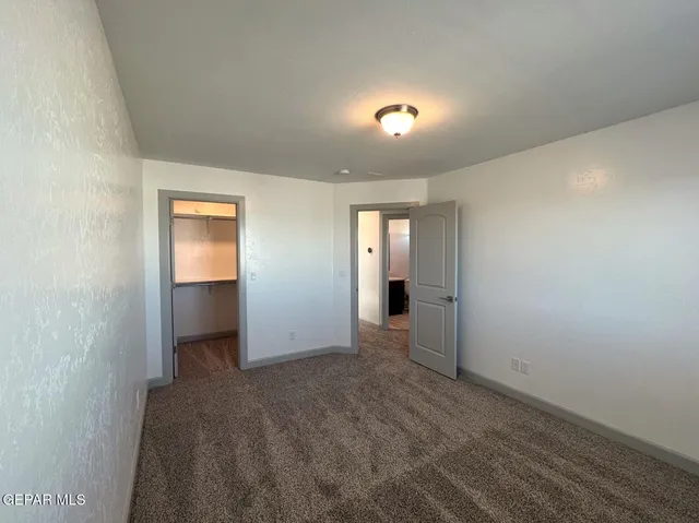 an empty room with a empty space and a ceiling fan