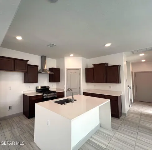a kitchen with stainless steel appliances a stove sink and microwave