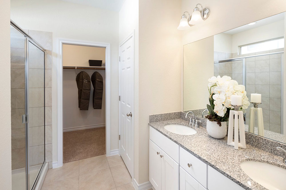 1608 Jonas Cove Pflugerville, TX 78660 - Photo 7 of 25 a bathroom with a granite countertop sink and a mirror