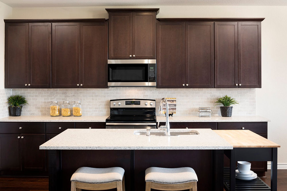1608 Jonas Cove Pflugerville, TX 78660 - Photo 9 of 25 a kitchen with a sink a microwave and cabinets