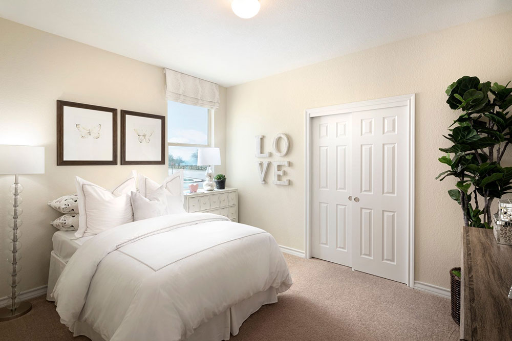 1608 Jonas Cove Pflugerville, TX 78660 - Photo 10 of 25 a bedroom with a large bed and a potted plant