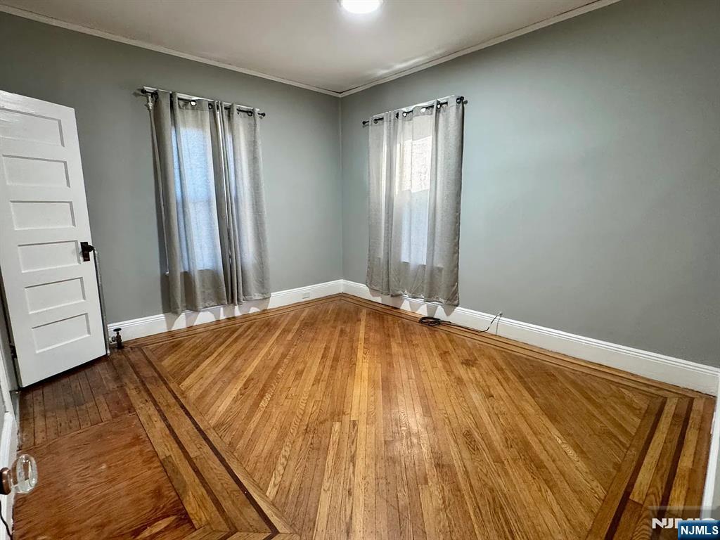 57 Maolis Avenue, Unit 2 Bloomfield, NJ 07003 - Photo 14 of 22 a bedroom with a bed and wooden floor