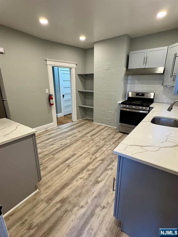 57 Maolis Avenue, Unit 2 Bloomfield, NJ 07003 - Photo 17 of 22 a kitchen with a stove and a refrigerator