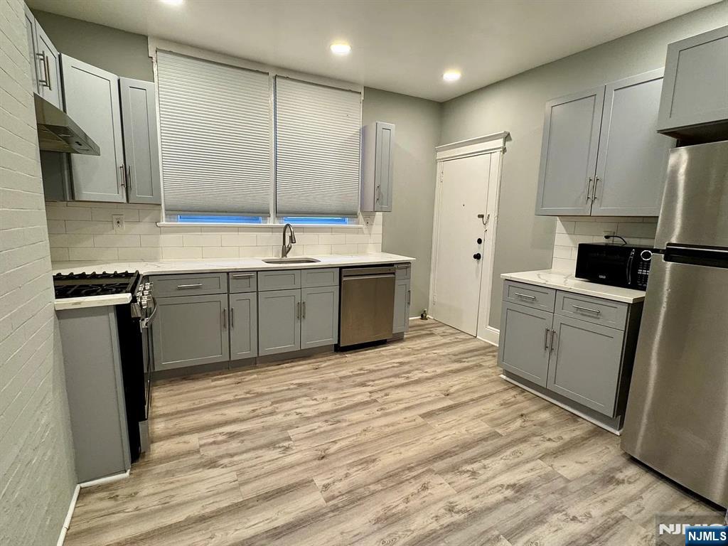 57 Maolis Avenue, Unit 2 Bloomfield, NJ 07003 - Photo 19 of 22 a kitchen with a sink refrigerator and cabinets