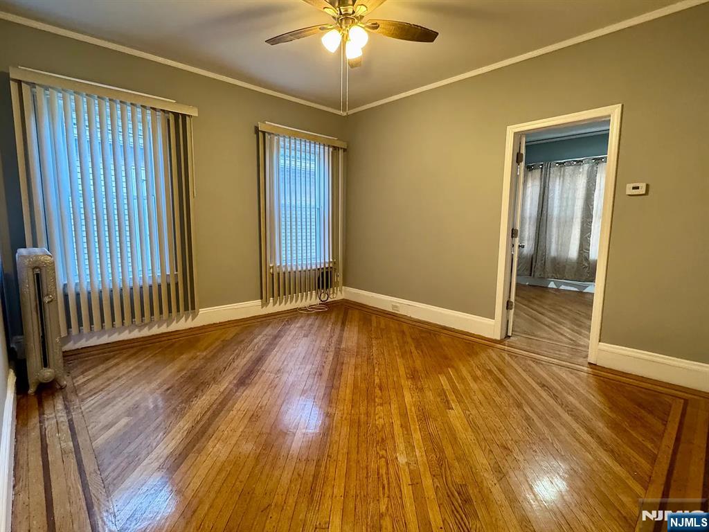 57 Maolis Avenue, Unit 2 Bloomfield, NJ 07003 - Photo 8 of 22 wooden floor in an empty room with a window