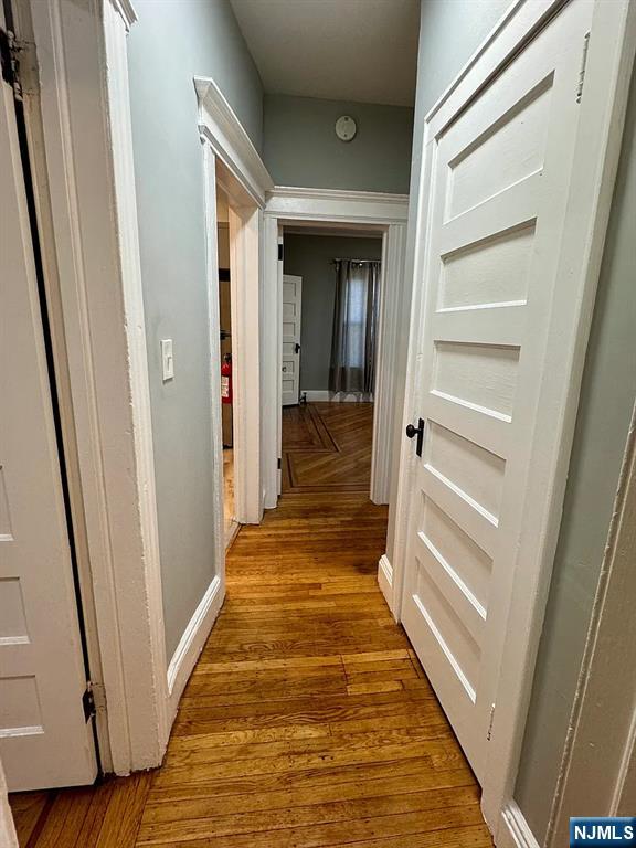 57 Maolis Avenue, Unit 2 Bloomfield, NJ 07003 - Photo 10 of 22 a view of a hallway with wooden floor and staircase