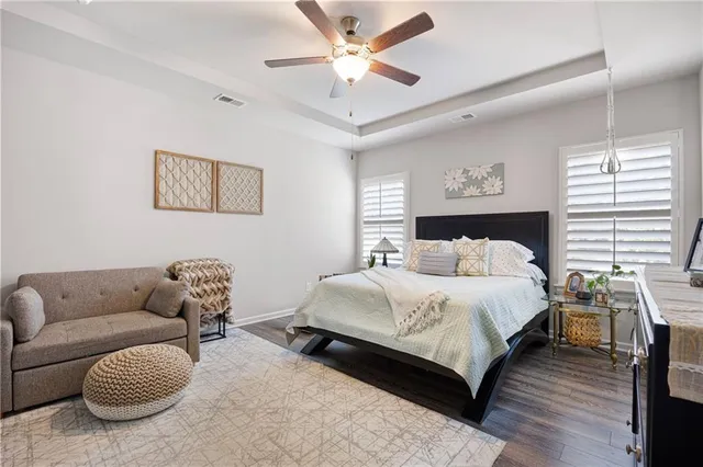 a bedroom with bed couch and window