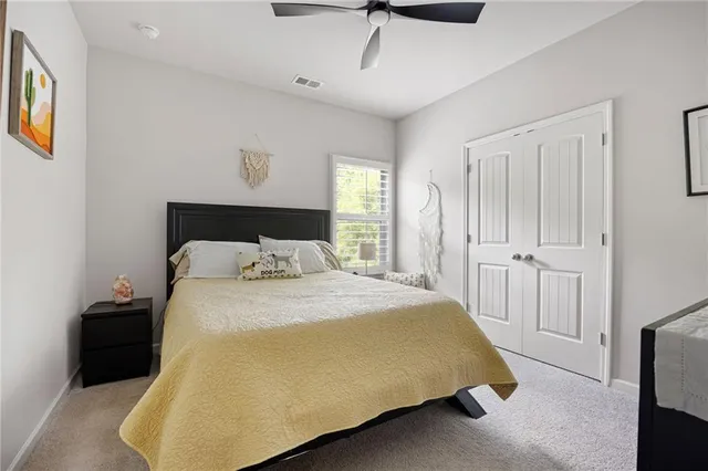 a bedroom with a bed and a painting on the wall