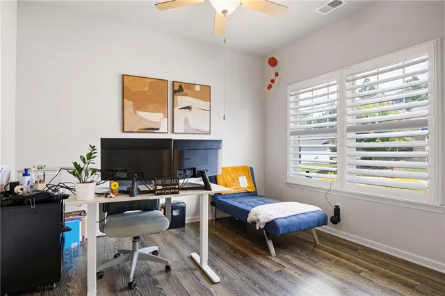 a living room with furniture a fireplace and a large window
