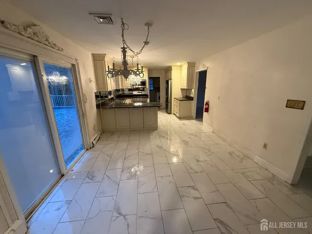 a front view of a house with a garden and plants