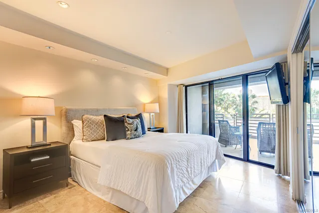 a bedroom with a large bed and a lamp