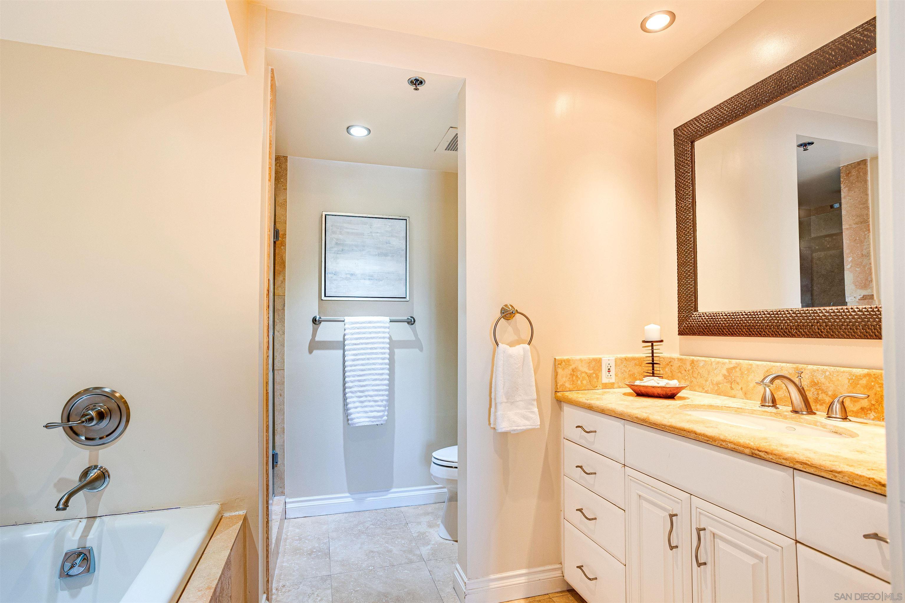 100 Harbor Drive, Unit 505 San Diego, CA 92101 - Photo 12 of 33 a bathroom with a granite countertop sink and a mirror
