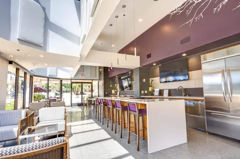 a kitchen with stainless steel appliances kitchen island granite countertop a refrigerator and a stove