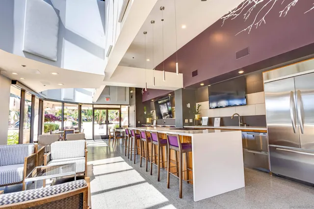 a kitchen with stainless steel appliances kitchen island granite countertop a refrigerator and a stove