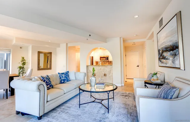 a living room with furniture and a potted plant