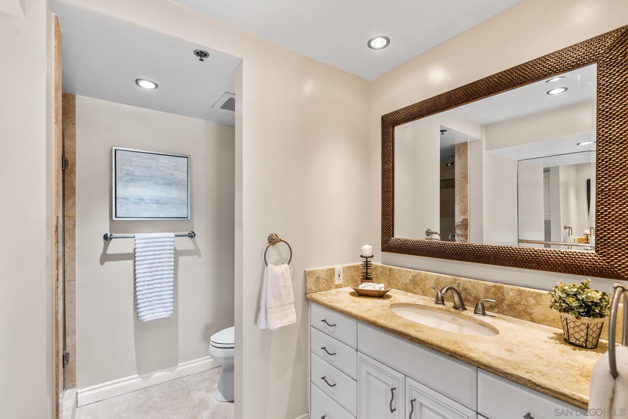 100 Harbor Drive, Unit 505 San Diego, CA 92101 - Photo 32 of 33 a bathroom with a granite countertop sink toilet and mirror