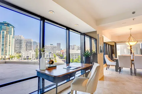 a living room with furniture and large windows