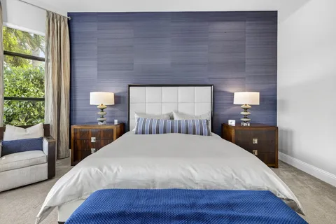 an aerial view of residential houses with outdoor space and lake view