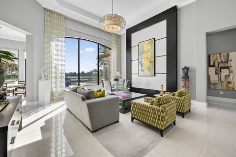 a living room with couch and a floor to ceiling window