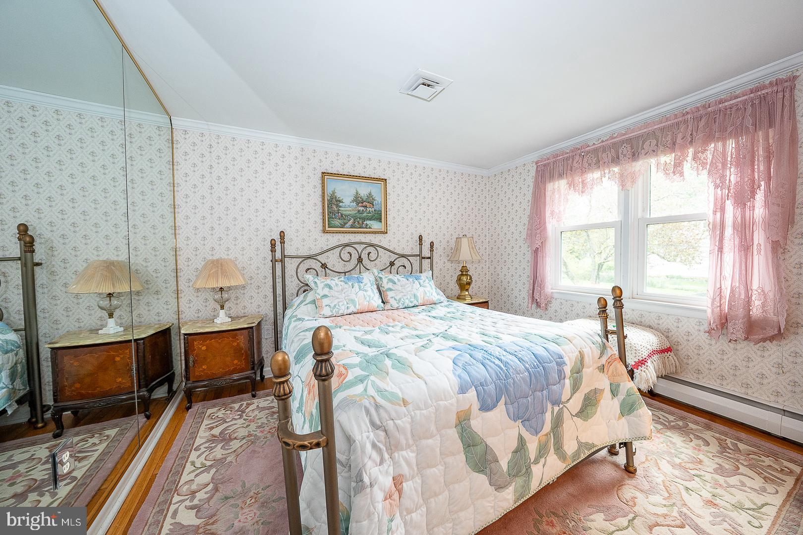9 Buckwalter Road Audubon, PA 19403 - Photo 16 of 35 a bedroom with a bed and wooden floor
