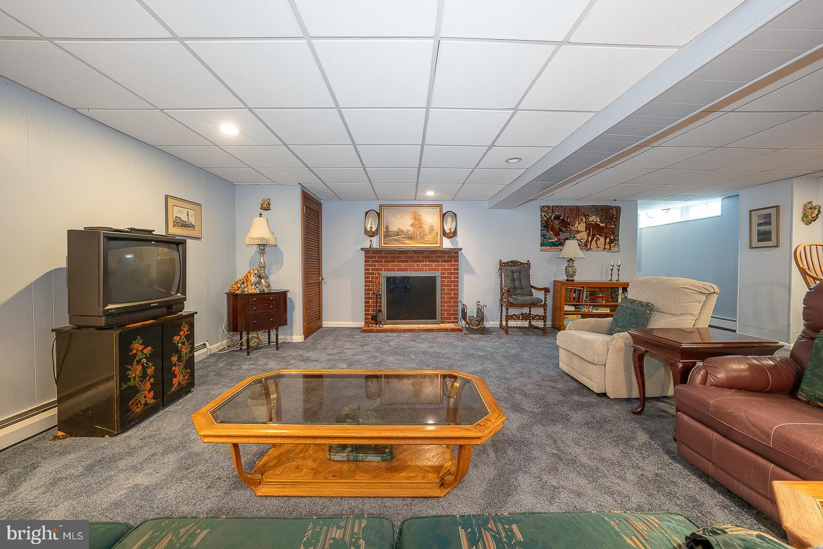 9 Buckwalter Road Audubon, PA 19403 - Photo 20 of 35 a living room with furniture a flat screen tv and a fireplace