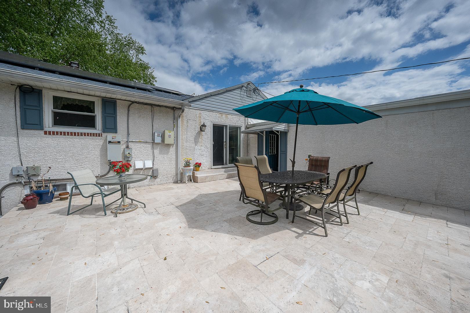 9 Buckwalter Road Audubon, PA 19403 - Photo 27 of 35 a view of a patio with a table and chairs under an umbrella