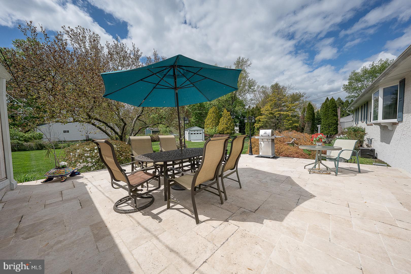 9 Buckwalter Road Audubon, PA 19403 - Photo 28 of 35 a view of the patio with a table and chairs under an umbrella