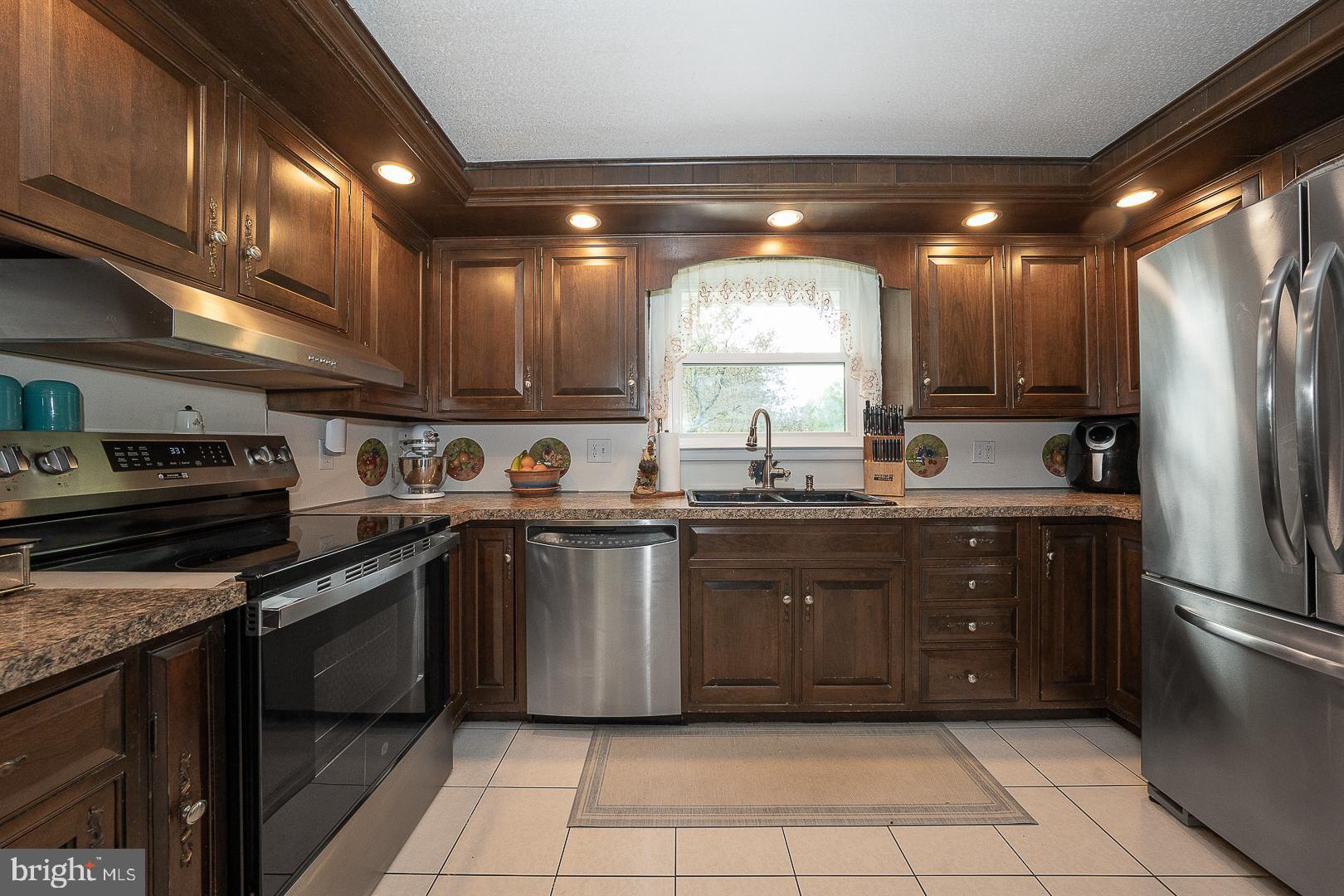 9 Buckwalter Road Audubon, PA 19403 - Photo 6 of 35 a kitchen with a sink cabinets and stainless steel appliances
