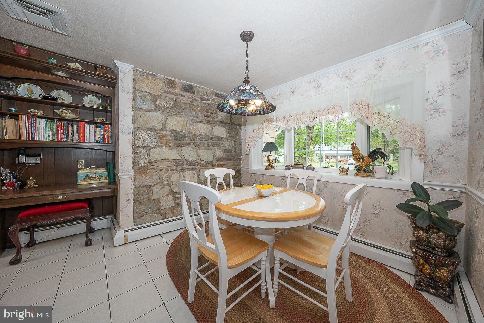 9 Buckwalter Road Audubon, PA 19403 - Photo 8 of 35 a dining room with furniture and a floor to ceiling window