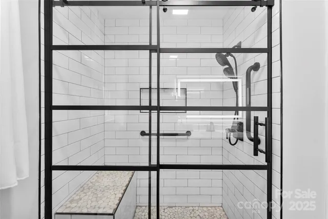 a bathroom with a glass shower door