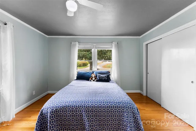 a bedroom with a bed and window