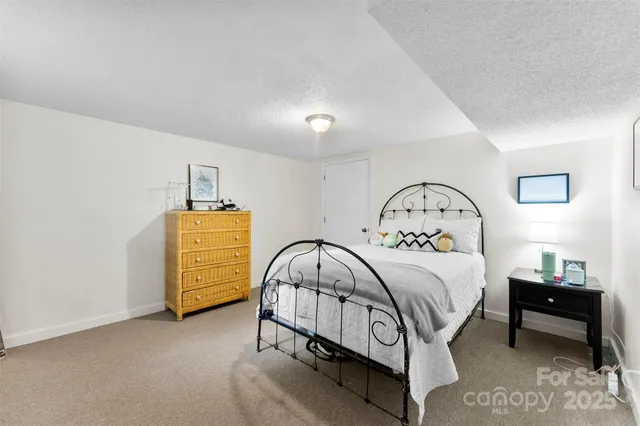 a bed room with a bed and a chair