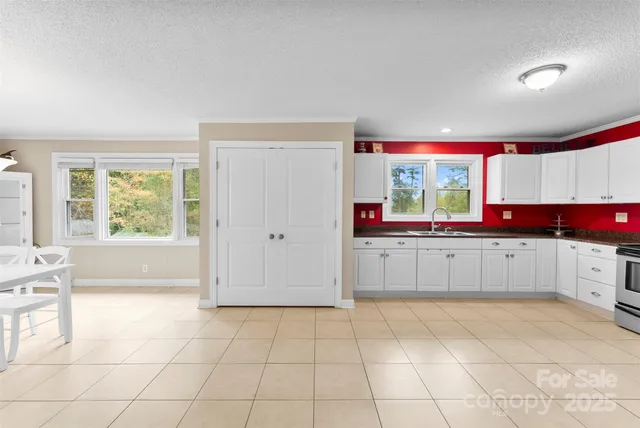 a kitchen with stainless steel appliances a cabinets and window