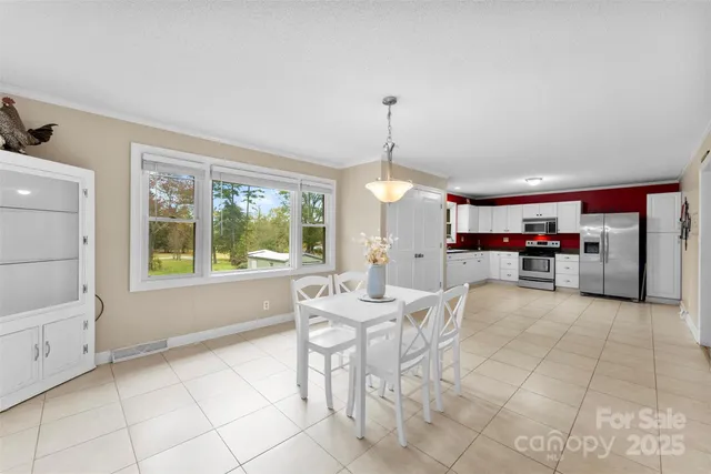 a kitchen with stainless steel appliances kitchen island granite top and refrigerator