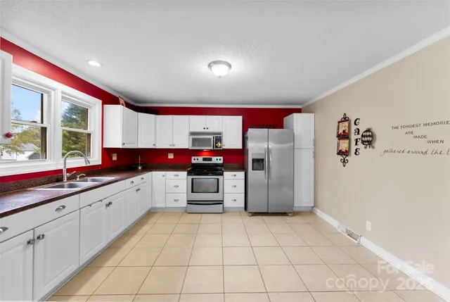 a large white kitchen with a large window